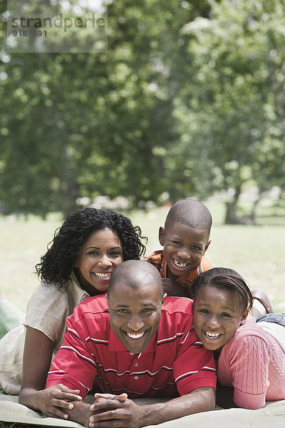 Family relaxing together in park