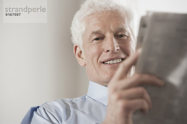 Caucasian businessman reading newspaper