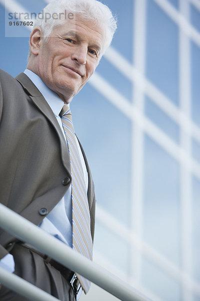 Caucasian businessman standing on balcony