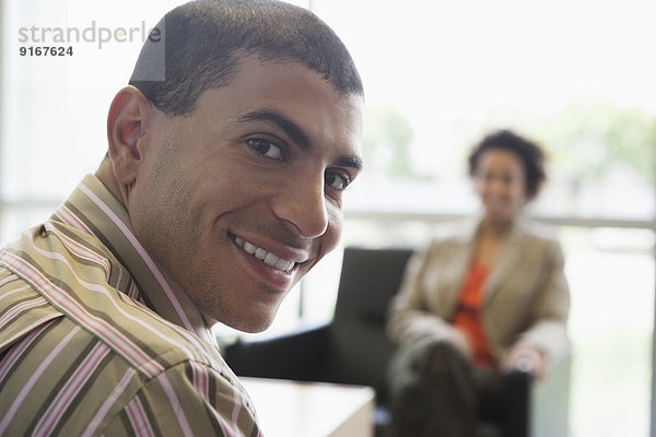 Hispanic businessman smiling in office