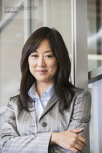 Asian businesswoman smiling in office