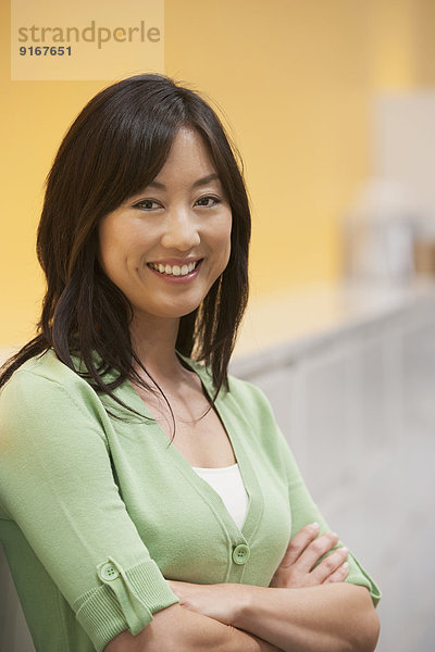 Asian businesswoman smiling in office