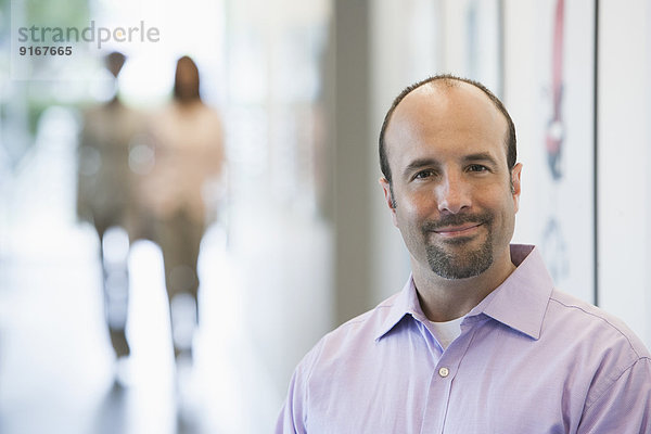 Caucasian businessman smiling in office