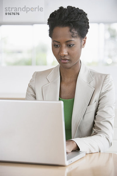 Businesswoman working on laptop at desk