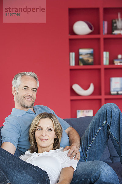 Couple relaxing together in living room