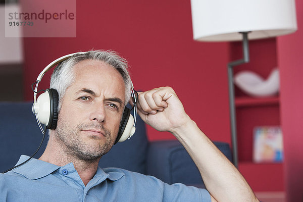 Man listening to headphones in living room