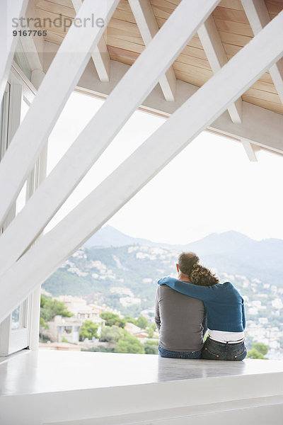 Couple admiring view from balcony