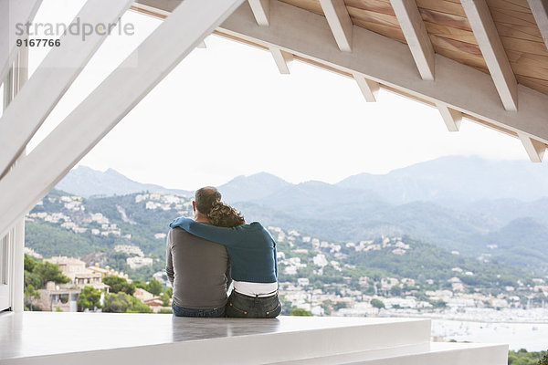 Couple admiring view from balcony