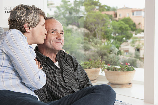 Couple relaxing together in living room