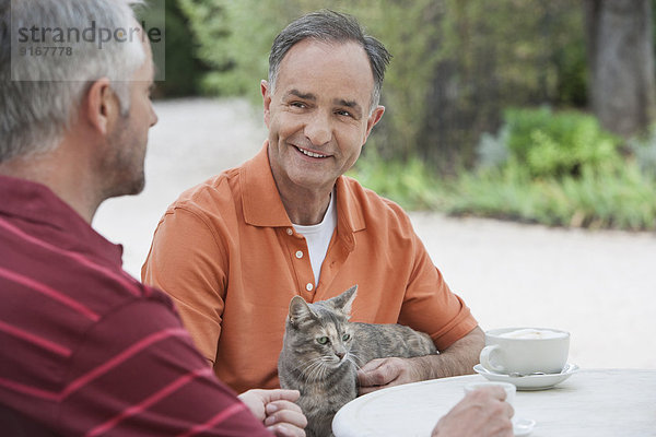 Men having coffee together outdoors