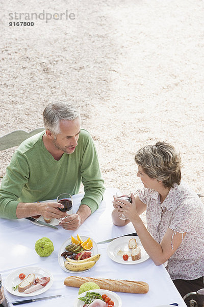 Couple eating together outdoors