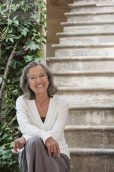 Woman sitting on front steps