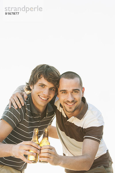 Men drinking beer together outdoors