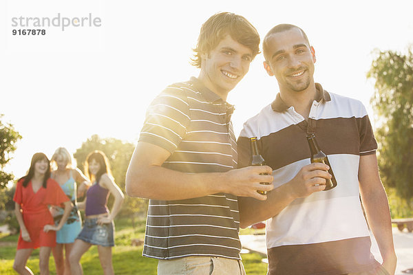 Men drinking beer together at party