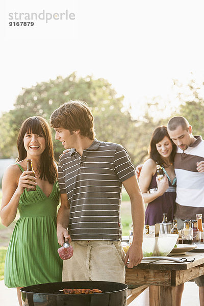 Friends having barbecue outdoors