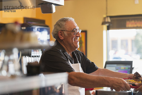 Hispanic server working in cafe