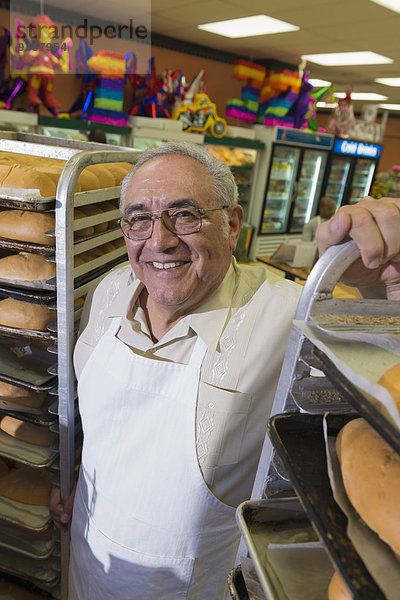 Hispanic baker working in commercial kitchen
