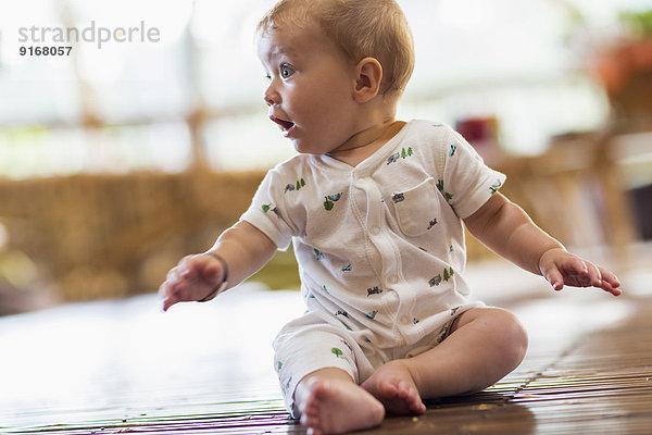 Caucasian baby sitting on floor