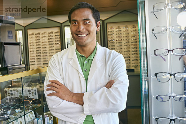 Filipino optometrist smiling in office