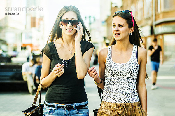 Women walking together on city street