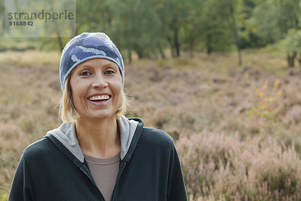 Caucasian woman smiling in rural field