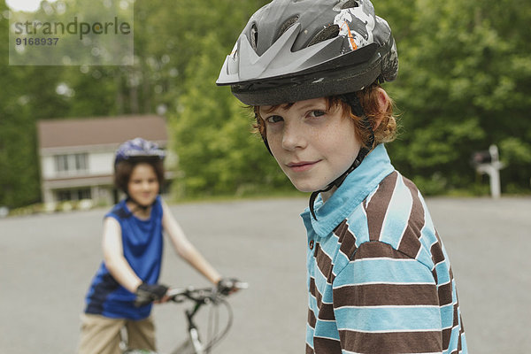 Boys riding bicycles together outdoors