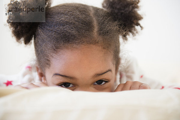 Black girl playing on bed