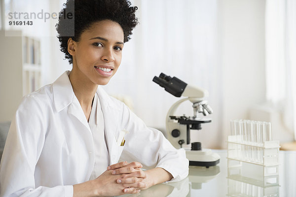 Black scientist smiling in lab