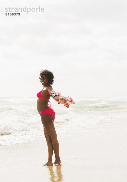 African American woman standing on beach
