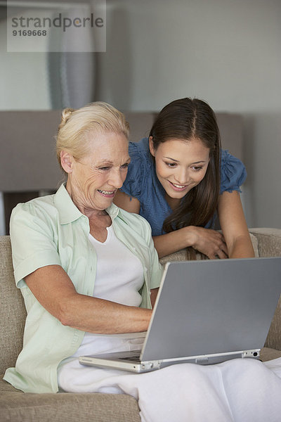 Caucasian mother and daughter using laptop