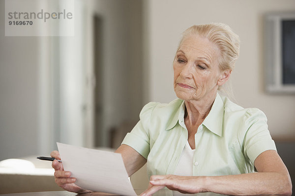 Senior Caucasian woman reading letter