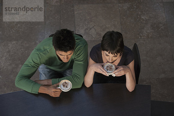 Caucasian couple drinking coffee together