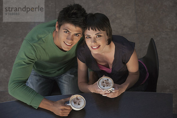 Caucasian couple drinking coffee together