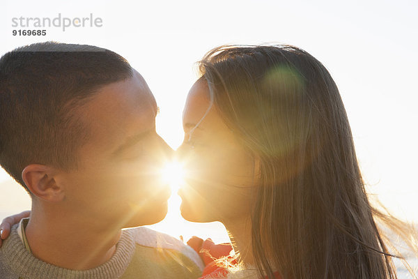 Caucasian couple kissing outdoors