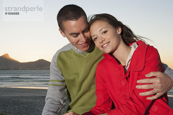 Caucasian couple hugging outdoors