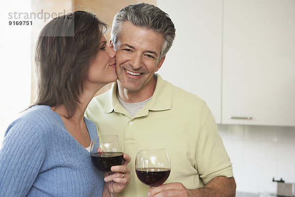 Hispanic couple having wine together