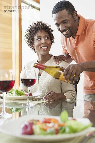 African American couple having wine at dinner