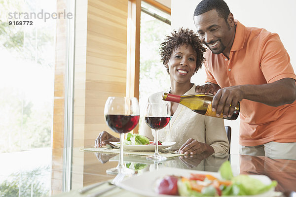 African American couple having wine at dinner