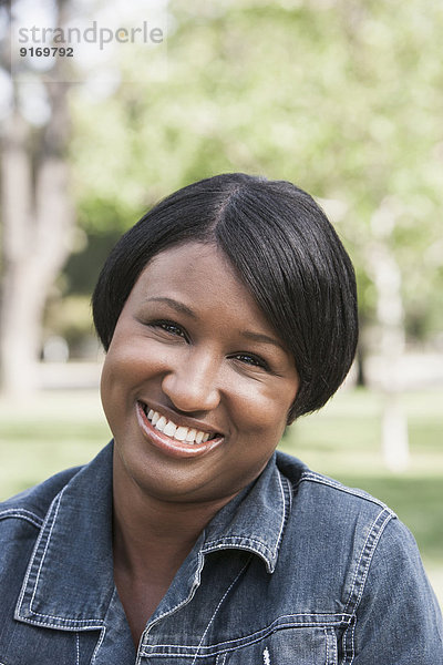 African American woman smiling in park