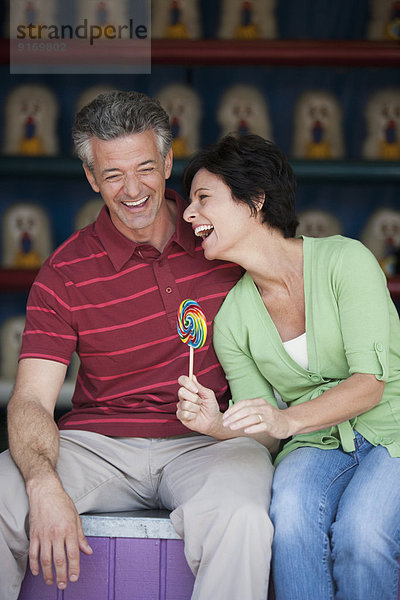 Caucasian couple relaxing at theme park