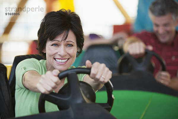 Caucasian woman driving bumper car