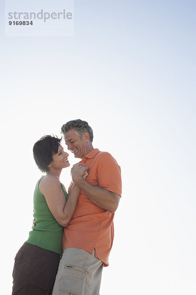 Caucasian couple hugging outdoors