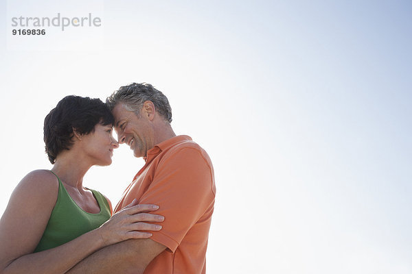 Caucasian couple hugging outdoors