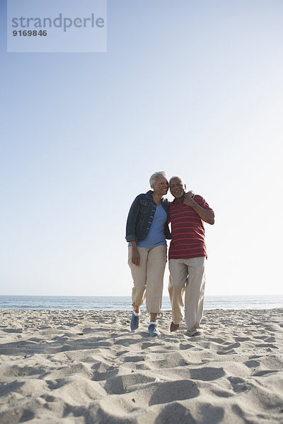 Senior African American couple walking on beach