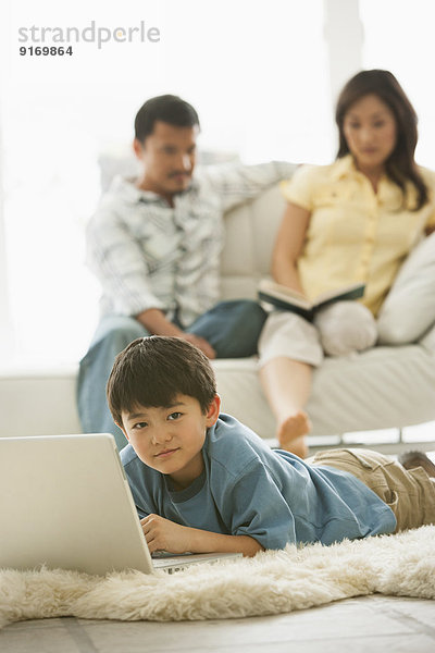 Boy using laptop in living room