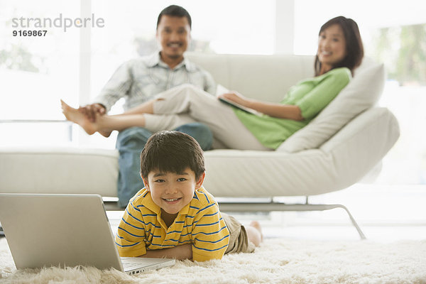 Boy using laptop in living room