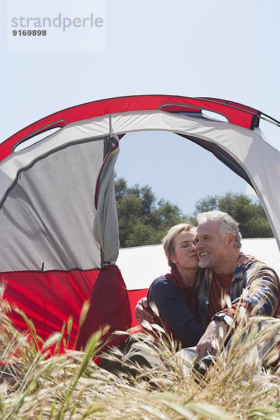 Senior Caucasian couple relaxing at campsite