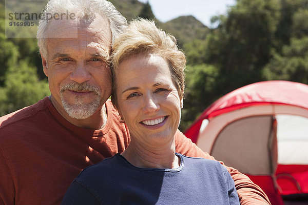 Senior Caucasian couple smiling outdoors