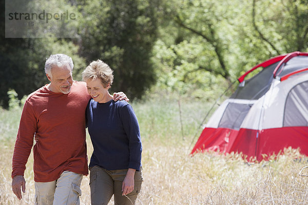 Senior Caucasian couple walking in rural field