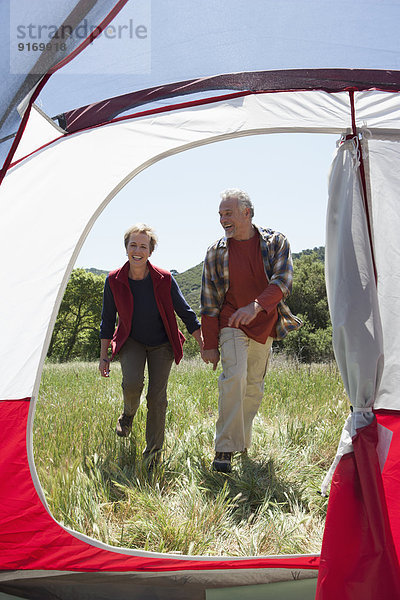 Senior Caucasian couple walking to campsite